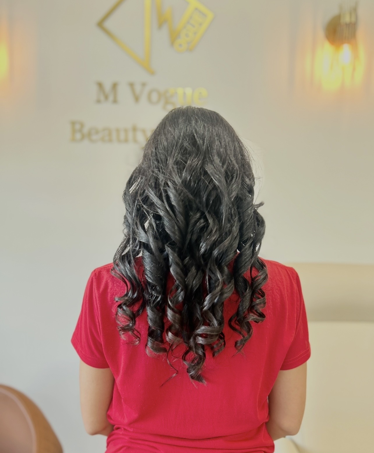 Shiny black curls styled at M Vogue Beauty Salon