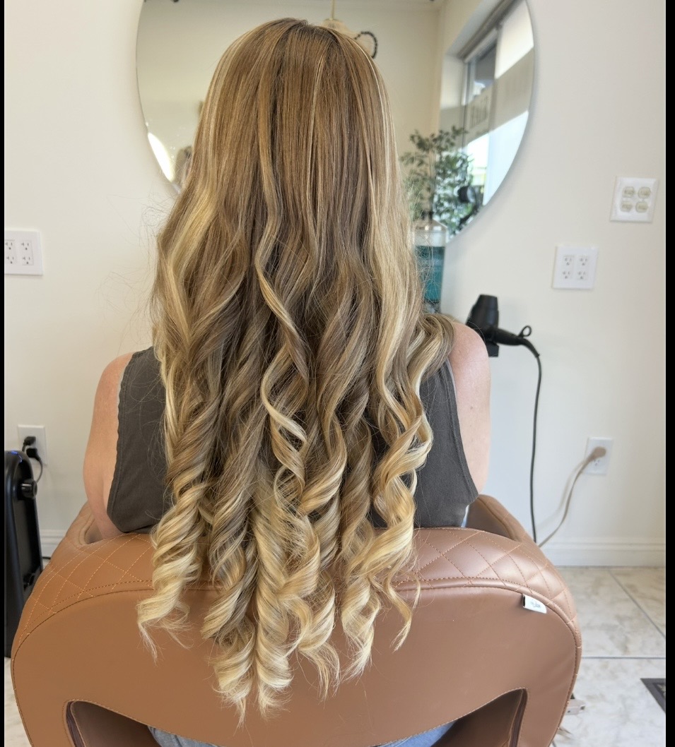 Long blonde balayage curls at M Vogue Beauty Salon
